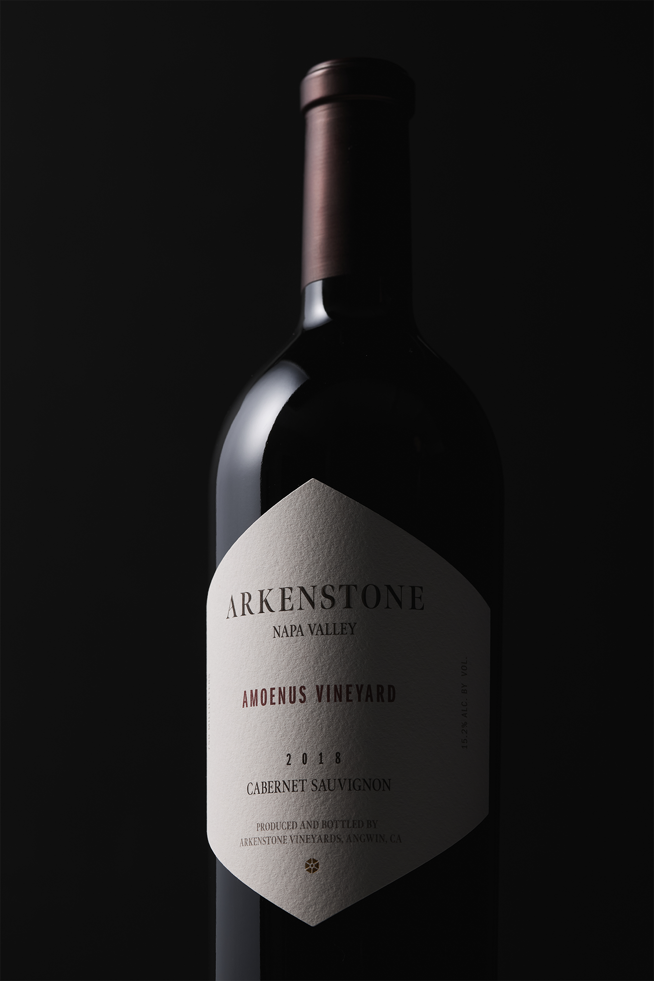 A bottle of 2018 Amoenus Vineyard Cabernet Sauvignon is showcased against a dark background, highlighting its label.